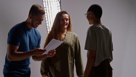 Film-Director-Talking-With-Male-And-Female-Actors-Holding-Scripts-Rehearsing-For-Shooting-Movie-Or-Video-In-Studio-9